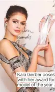  ??  ?? Kaia Gerber poses with her award for model of the year .