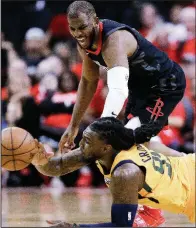 ?? AP/ERIC CHRISTIAN SMITH ?? Houston Rockets guard Chris Paul (top) finished with 17 points in the Rockets’ 110-96 victory over the Utah Jazz on Sunday at the Toyota Center in Houston. Houston leads the best-of-seven series 1-0.