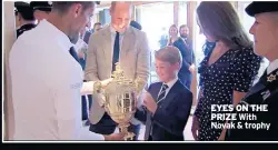  ?? ?? EYES ON THE PRIZE With Novak & trophy