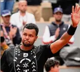  ?? Michel Euler / Associated Press ?? Jo-wilfried Tsonga waves to the public after losing to Casper Ruud at the French Open. Tsonga is heading into retirement.