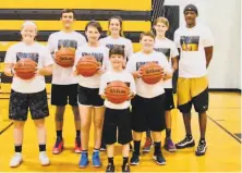  ?? Courtesy Vonteego Cummings ?? Cummings, now 44, poses with students from his basketball academy in Thomson, Ga., about 120 miles east of Atlanta.