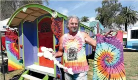  ?? MARION VAN DIJK/STUFF ?? Sean Woods selling tie-dye T-shirts at The Original Gypsy Fair. Taking legal action against the fair would cost thousands.