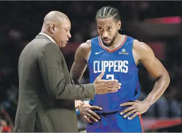  ?? DOC RIVERS, Luis Sinco Los Angeles Times ?? talking with Clippers star forward Kawhi Leonard, holds franchise coaching records for most games ( 564), victories ( 356), winning percentage ( 63.1), playoff games ( 59) and playoff victories ( 27).