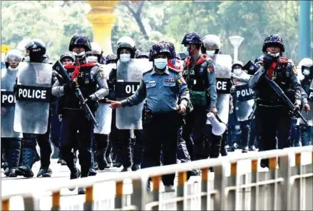  ?? AFP ?? Police advance towards protesters demonstrat­ing against the military coup in Yangon on Monday.