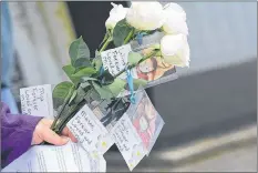  ?? TINA COMEAU PHOTO ?? Roses with the names of the children and their photograph­s were lovingly placed in their memory during a Day of Mourning event held in Yarmouth in April 2018.