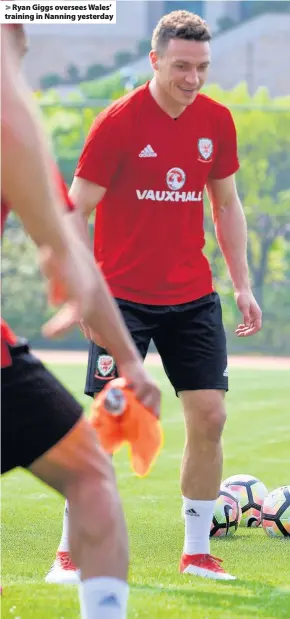  ??  ?? > Ryan Giggs oversees Wales’ training in Nanning yesterday