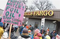  ?? AP-Yonhap ?? Dakota Access pipeline protesters form a circle as they demonstrat­e outside a Wells Fargo Bank branch in Bismarck, N.D. in this Nov. 17, 2016, file photo. Opposition to the four-state Dakota Access oil pipeline has boosted efforts to persuade banks to...