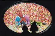  ?? ?? People look at a painting by Kehinde Wiley titled “Christian Martyr Tarcisius.”