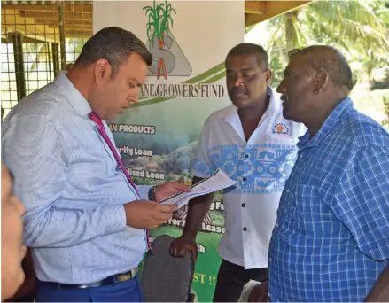  ?? Photo: Laisa Lui. ?? Minister for Lands and Mineral Resources Ashneel Sudhakar looks at a document concerning land issues raised by Dur Sami(right).