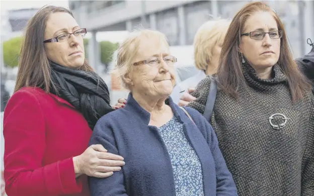  ??  ?? 0 Joe Mccann’s widow Anne, centre, is surrounded by family after leaving the court after the case against the two former paratroope­rs collapsed