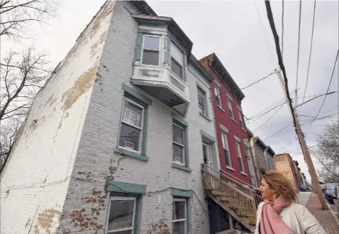  ?? Photos by Will Waldron / Times Union ?? Jessica Rowell looks over her First Street property in Albany, which she plans to renovate for apartments.