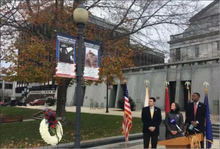  ?? CARL HESSLER JR. - DIGITAL FIRST MEDIA ?? The Montgomery County commission­ers view the latest “Hometown Hero” banner unveiled at courthouse on Veterans Day to honor Marine Capt. Samuel Schultz, 28, of Abington.