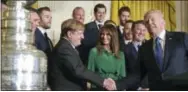  ?? SUSAN WALSH — THE ASSOCIATED PRESS ?? President Donald Trump, right, shakes hands with Penguins owner Ronald Burkle, third from left, as first lady Melania Trump, center in green, watches, with Mario Lemieux during a ceremony to honor the 2017 Stanley Cup champion Penguins Tuesday at the White House.