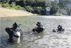  ?? PHOTO: SUPPLIED / NZ POLICE ?? A police dive squad searches for clues about Tuitania Barclay’s disappeara­nce at Ross Creek in Dunedin in 2014.