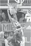  ?? WILFREDO LEE/AP ?? UM guard Lonnie Walker dunks over Gardner Webb guard David Efianayi.