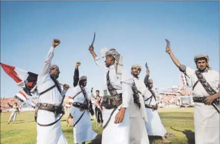  ?? HANI MOHAMMED — THE ASSOCIATED PRESS ?? Supporters of Houthi Shiites, who took over the government of Yemen and installed a new committee to govern, wave traditiona­l daggers and chant slogans at a rally in support of the Houthis at a sports stadium in Sanaa, Yemen, on Saturday.