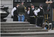  ?? Frank Augstein / Associated Press ?? Police speak to a man with a microphone in London after the government told people to stay home.