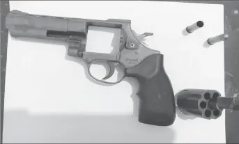  ??  ?? The .38 revolver, single live round and single spent shell that were found on the passenger of a bus that was stopped along the Soesdyke-Linden Highway