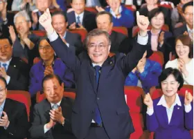  ?? SeongJoon Cho / Bloomberg ?? Moon Jae-in reacts after exit poll results are announced at his party’s headquarte­rs in Seoul and his two main rivals conceded defeat.