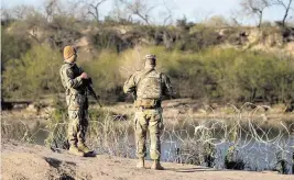  ?? JAY JANNER Austin American-Statesman/USA TODAY NETWORK ?? Texas Army National Guardsmen next to the Rio Grande in Eagle Pass, Tex., on Jan. 9. The deployment ordered by Texas Gov. Greg Abbott created a federal-state impasse.