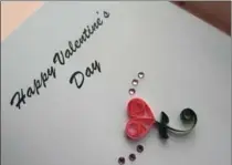  ??  ?? Two teardrop coils and two smaller bent teardrop coils combine with an open coil scroll to create a Valentine’s Day message.