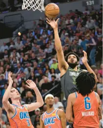  ?? Heat 102, Bulls 91:
ABBIE PARR/AP ?? Minnesota Timberwolv­es center Karl-Anthony Towns puts up a shot over Oklahoma City Thunder forward Jaylin Williams during Friday night’s play-in tournament game.