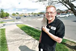  ?? AP Photo/David Zalubowski ?? Bill Easton, a Safeway grocery store cashier, is shown in the shopping center where the store is located Wednesday in Aurora, Colorado. Easton, like many other workers in retail sales jobs, is fully vaccinated but is concerned about risks posed as retailers change their mask-wearing policies for customers.