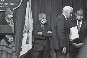  ?? ASSOCIATED PRESS FILE PHOTO ?? Vice President Mike Pence, unmasked, walks offstage following a briefing Friday with the White House coronaviru­s task force at the Department of Health and Human Services in Washington. Task force members Dr. Deborah Birx, from left, Dr. Anthony Fauci and Health and Human Services Secretary Alex Azar wear masks.