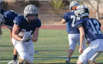  ?? Eddy Martinez/ The Signal (See additional photos on signalscv.com) ?? (Above) Nick Schiener carries the ball Wednesday afternoon at Saugus High School. (Below) Saugus High School’s football team practices Wednesday afternoon for the upcoming 2018 football season.