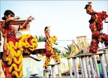  ?? AFP ?? At the Tu Anh Duong lion and dragon dance school, performers mimic the movements of the creatures to bring good luck and dispel evil spirits.