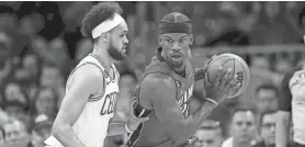  ?? DAVID BUTLER II/USA TODAY SPORTS ?? Heat forward Jimmy Butler looks to pass against Celtics guard Derrick White on Friday in Game 2 of the Eastern Conference final.