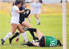  ??  ?? Bosque School’s Campbell Pacheco (16) goes to the ground for a save while Sandia Prep’s Ava Forrester is defended by Bosque’s Bella Corte, left.