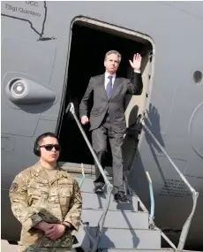  ?? — AFP photo ?? Blinken waves as he disembarks upon arrival at Cairo East Airport in Cairo.