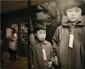  ?? PHOTO ?? In this photo taken Thursday is a 1942 photograph called Japanese Children with Tags that is in the exhibit "Dorothea Lange: Politics of Seeing," at the Oakland Museum of California in Oakland. AP