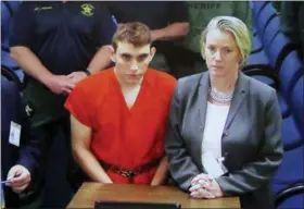  ?? SUSAN STOCKER — SOUTH FLORIDA SUN-SENTINEL (VIA AP) ?? A video monitor shows school shooting suspect Nikolas Cruz, left, making an appearance Thursday in Broward County Court in Fort Lauderdale, Fla.