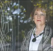  ?? (AP/Sue Ogrocki) ?? Lynne Gist looks out the front door of her home Wednesday in Midwest City, Okla. Gist lost her sister, Karen Gist Carr, in the 1995 bombing.