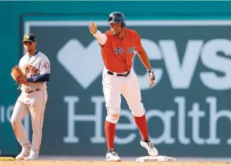  ?? WINSLOW TOWNSON/ASSOCIATED PRESS ?? Boston’s Xander Bogarts signals towards his dugout after his RBI double against the Houston Astros during the seventh inning of the Red Sox win.