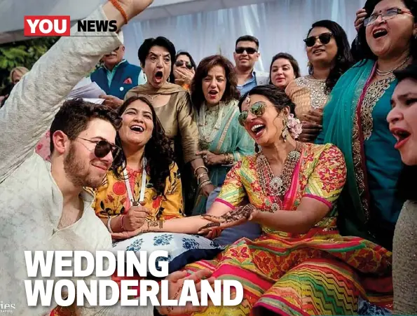  ??  ?? ABOVE: Nick and Priyanka had henna applied to their hands for the mehendi ceremony as guests watched. ABOVE RIGHT: Priyanka’s vibrant dress was designed by couture label Abu Jani Sandeep Khosla.