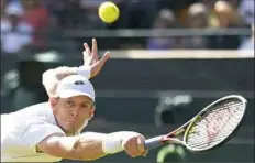  ??  ?? Kevin Anderson reaches for a return against Roger Federer.