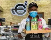  ?? KAMRAN JEBREILI/ AP ?? A waiter poses with a tray of baby bottles at Einstein Cafe in Dubai, United Arab Emirates. Cafes across several Gulf Arab states are selling coffee and other drinks in baby bottles, kicking off a new trend.