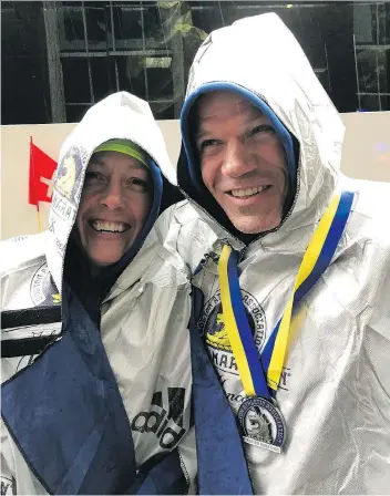  ?? JENNIFER MASUR ?? Regina’s Jennifer and Vern Masur, who wore “Humboldt Strong” and “Canada Strong” crests on their running shirts, bundled up after completing the Boston Marathon in frigid conditions Monday.