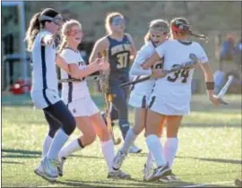  ??  ?? Times Staff / ERIC HARTLINE Episcopal Academy’s Margaux Paolino, second from right, is mobbed by teammates, from left, Taryn Gallagher, Maddie Bacskai and Tori Sarmiento after Paolino connected on a penalty stroke in the second half of the Churchmen’s...