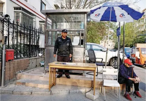  ?? File/reuters ?? Security guard Yang Xiping, 59, keeps watch at the entrance of a residentia­l compound in Beijing, China, on April 9, 2024.