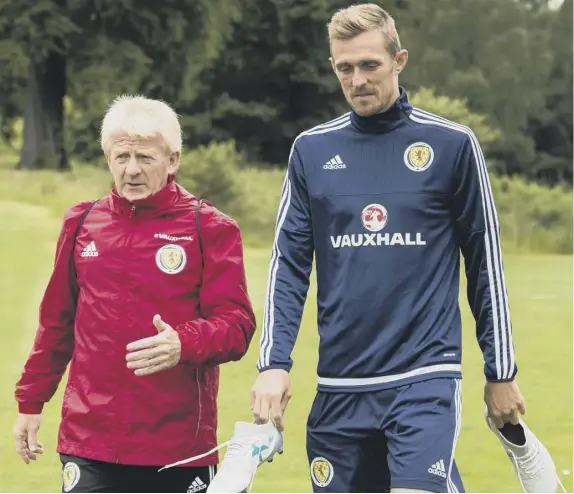  ??  ?? Scotland coach Gordon Strachan in discussion with Darren Fletcher during training at Mar Hall yesterday.