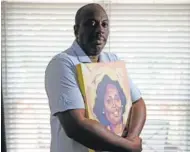  ?? AP PHOTO/CHRIS CARLSON ?? Malcolm Graham holds a painting of his late sister, Cynthia Graham-Hurd, last summer in Charlotte, N.C. Graham, a former state senator in North Carolina, firmly believes America’s failure to confront white supremacis­m cost the his sister her life.