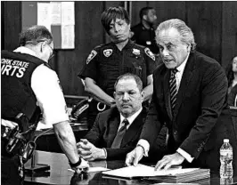  ?? STEVEN HIRSCH/NEW YORK POST ?? Film mogul Harvey Weinstein, seated, listens as his attorney confers with a court officer in New York. The GOP tax law stops victims and companies from deducting legal expenses.