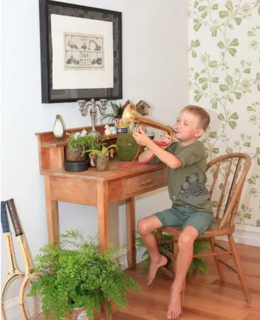  ??  ?? ABOVE: Lucas with his vintage finds. The print is called "The Constructi­on Game" by Kelvin Mann. It was Lucas’ first birthday present (his first word was digger).