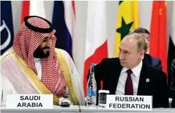  ??  ?? Mohammed bin Salman and Vladimir Putin at a working session of leaders at the G20 summit in Osaka. —