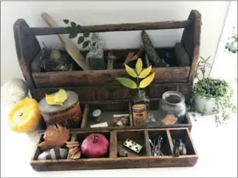  ?? KATIE WORKMAN VIA ASSOCIATED PRESS ?? This photo provided by Katie Workman shows a “cabinet of curiositie­s,” with touches of autumn, inside a home in New York.