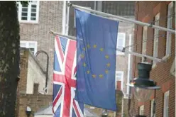  ?? — Reuters ?? EU and British flags fly outside the European Commission building in London.